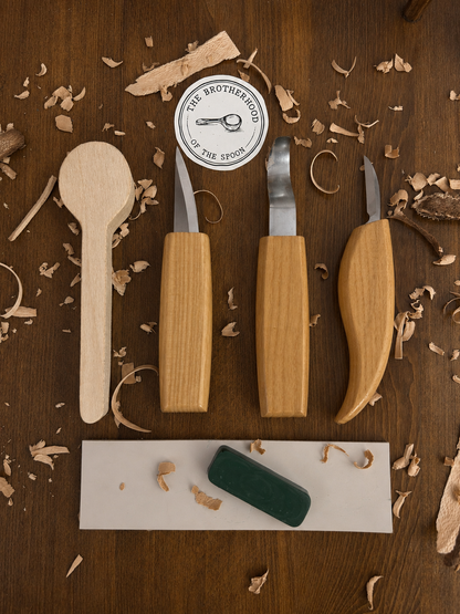 Woodworking tools on a wooden surface with 'The Brotherhood of the Spoon' logo.